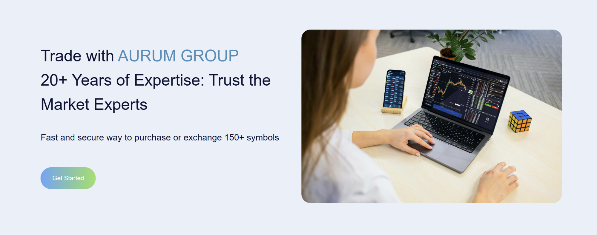 Trader using laptop with trading charts on AURUM GROUP platform